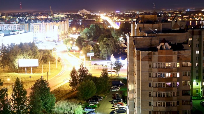 Night view of a city with buildings and a road