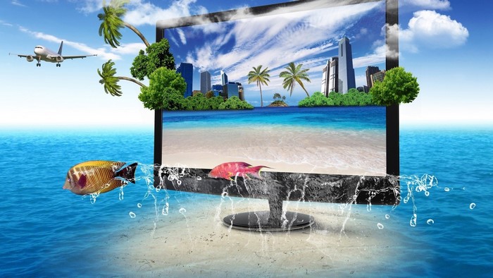 Monitor displaying tropical beach and city skyline