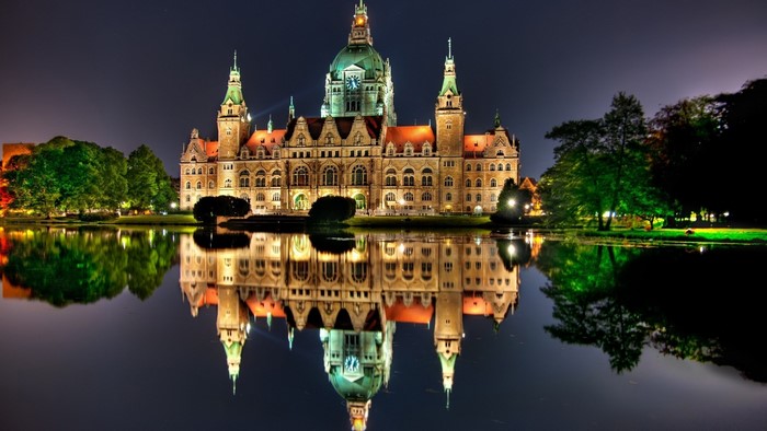 New Town Hall reflected in water at night