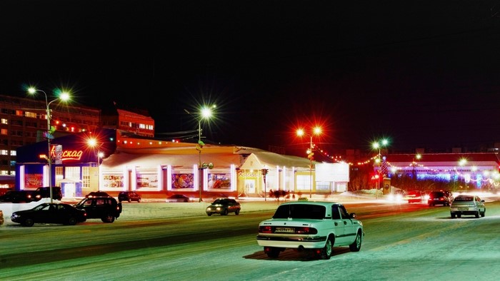 Vorkuta street scene at night with cars and buildings