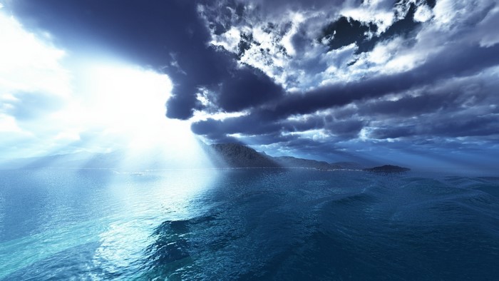 Sunlight breaking through clouds over the sea
