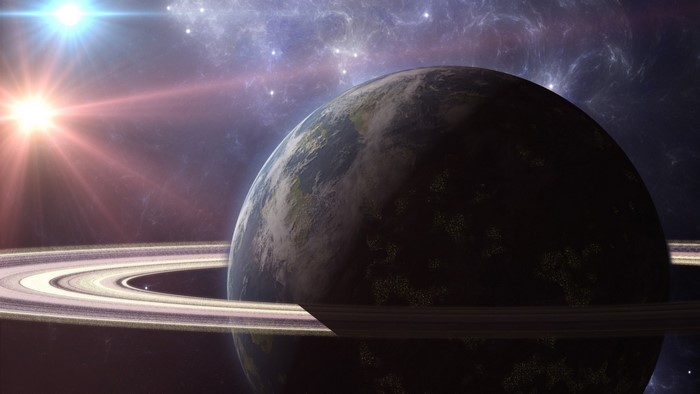 Planet with rings and sun in space