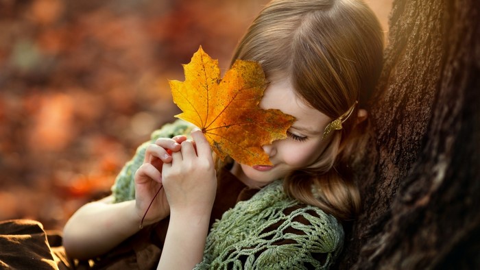 Girl holding a fall leaf