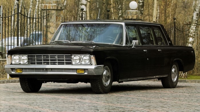 Black Zil limousine parked on cobblestone street