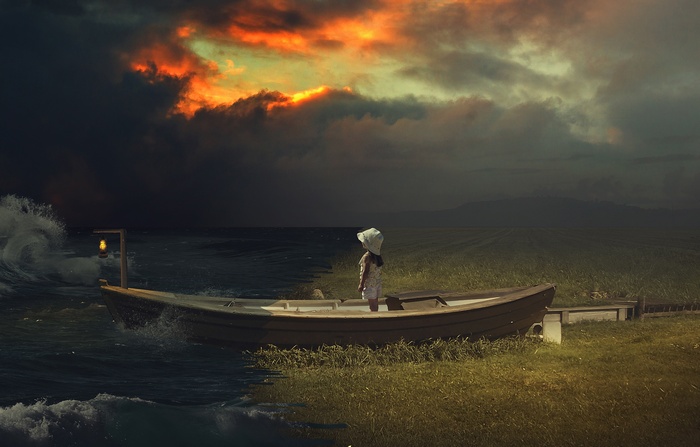 Girl in a boat with a lantern at sunset