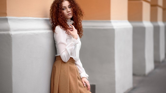 Young woman with curly red hair