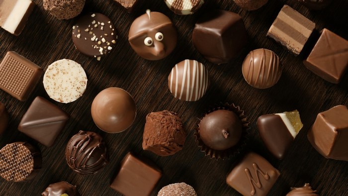 Assortment of gourmet chocolates on a wooden surface