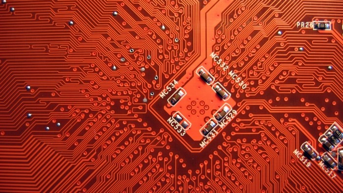 Close-up of a red circuit board with components
