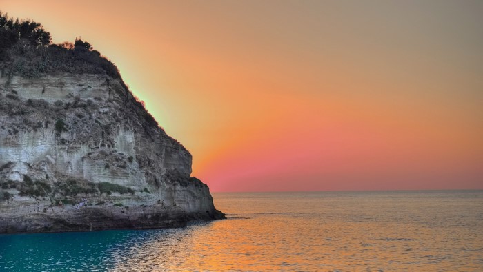 Coastal cliff at sunset over the ocean