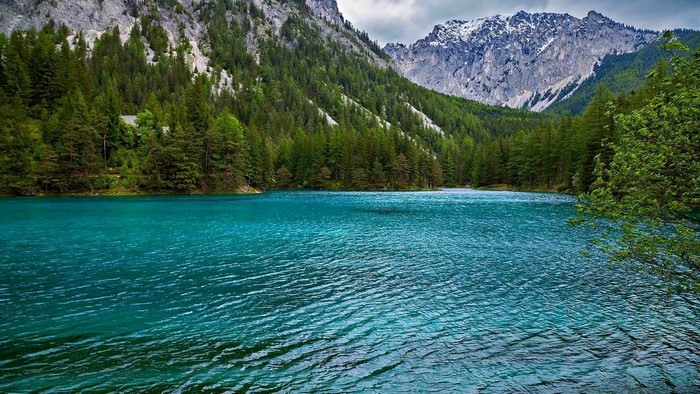 Turquoise lake in a mountain forest