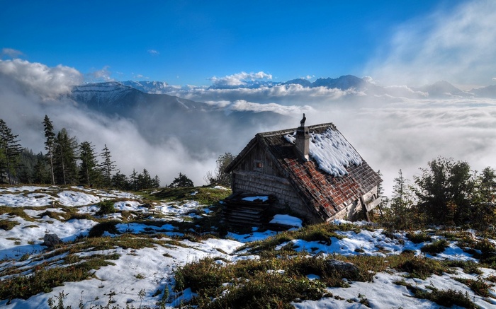 Cabin in the mountains above the clouds
