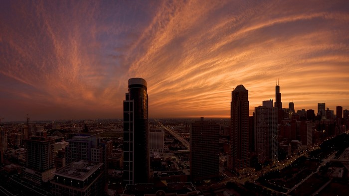 Chicago skyline at sunset with wispy clouds