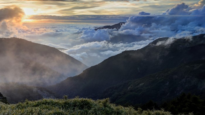 Clouds over mountain landscape at sunset