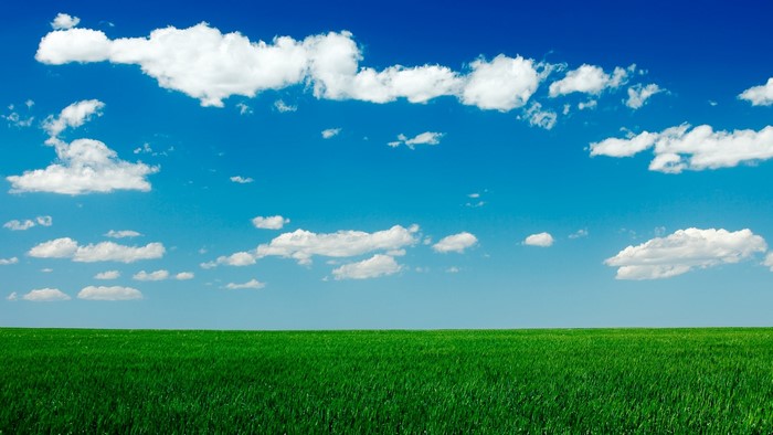 Blue Sky with Clouds Over Green Grass Field