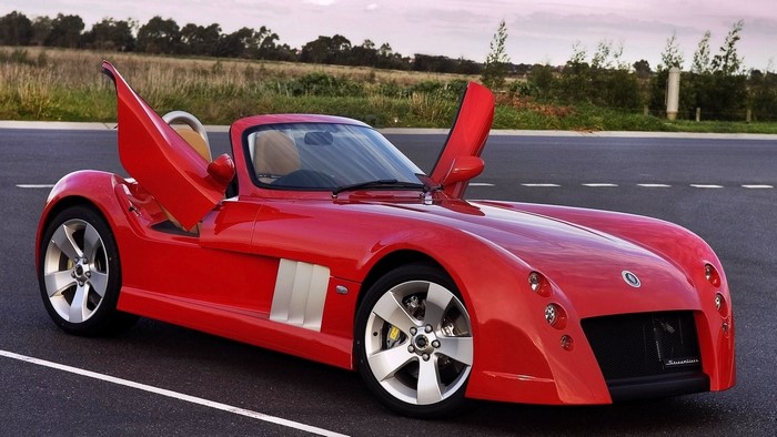 Red Elfin MS8 Streamliner sports car with doors open