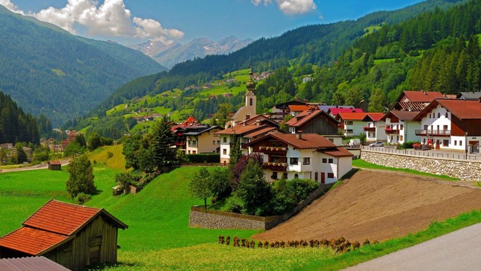 Alpine village with traditional houses and mountains