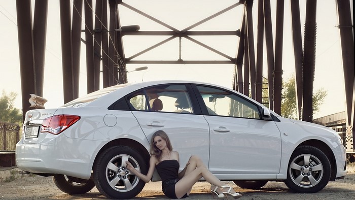 Girl posing with white Chevrolet Cruze
