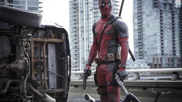 Deadpool with guns and overturned car