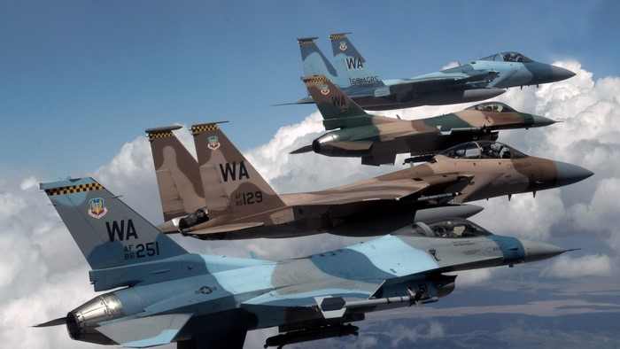 Four F-15 and F-16 fighter jets in formation
