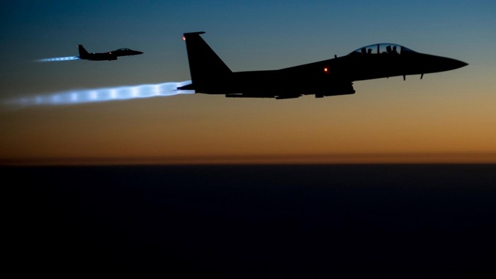 Two F-15 Eagles flying at dusk