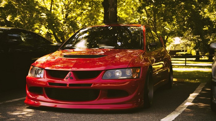 Red Mitsubishi Lancer Evolution IX parked outdoors