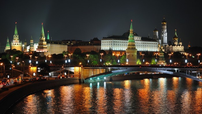 Moscow Kremlin at night with river reflection