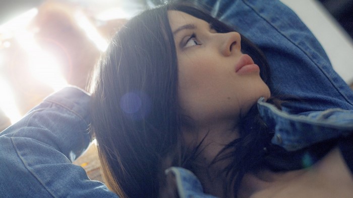 Girl in denim jacket looking up