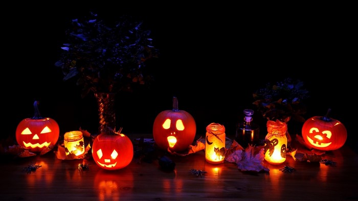 Halloween pumpkins and jars with candles