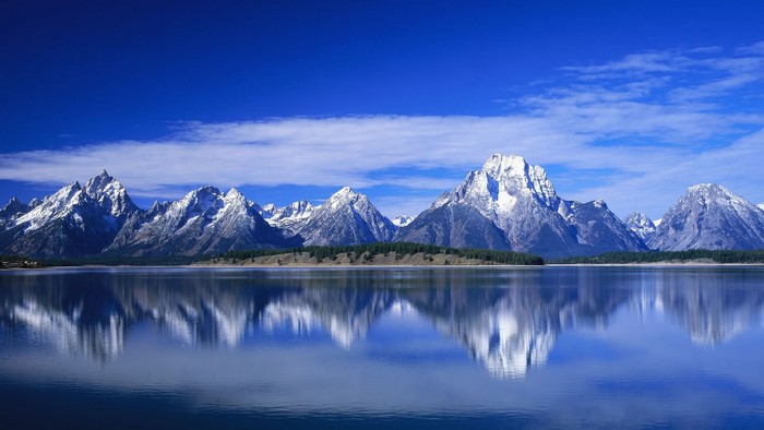 Snow-capped mountains reflected in a lake