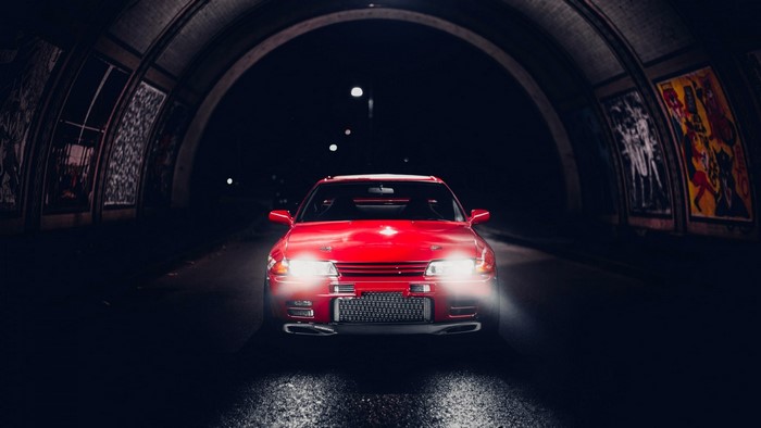 Red Nissan car in a tunnel