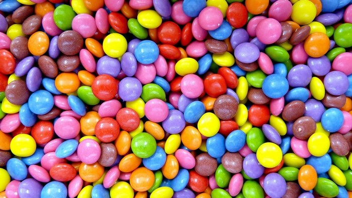 Colorful candy pieces scattered