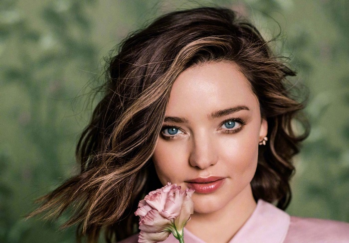 Miranda Kerr with a pink flower