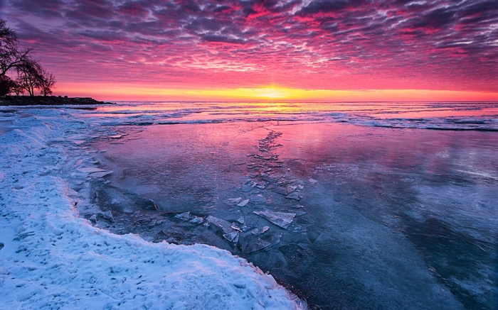 Frozen lake at sunrise with pink sky