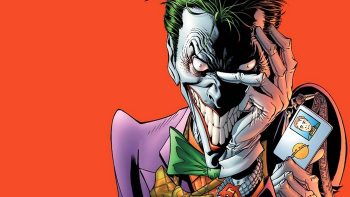 Joker holding a playing card
