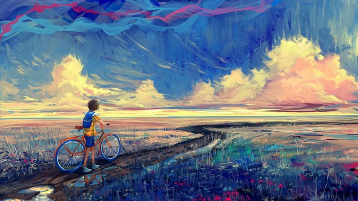 Boy with bicycle on a path through a field