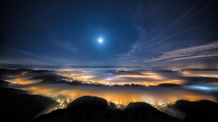Starry Night Over Misty Valley Cityscape