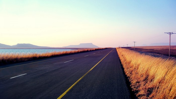 Highway Landscape with Lake and Mountains