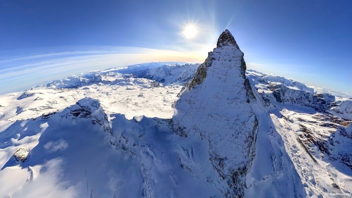 Snowy Mountain Peak Under Bright Sun