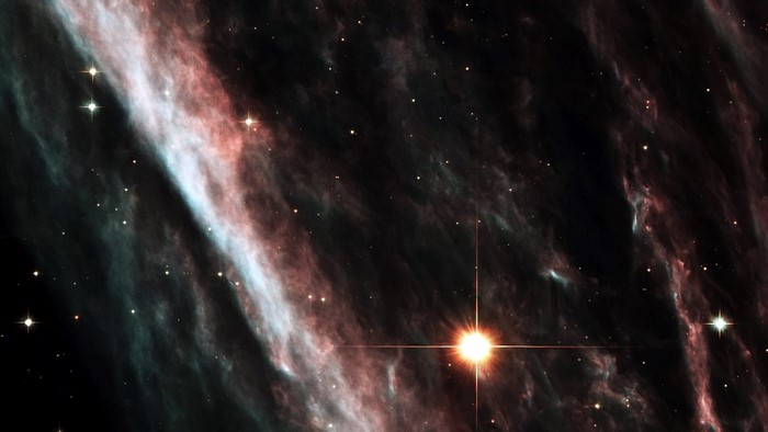 Nebula with stars and a bright star