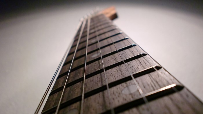 Close-up of a guitar neck with strings and frets