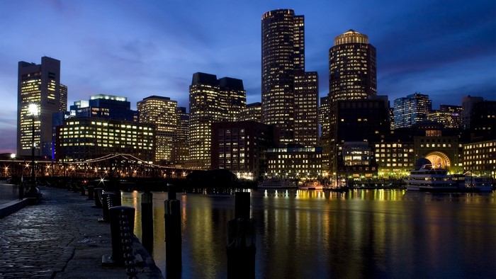 Night cityscape with illuminated skyscrapers and waterfront
