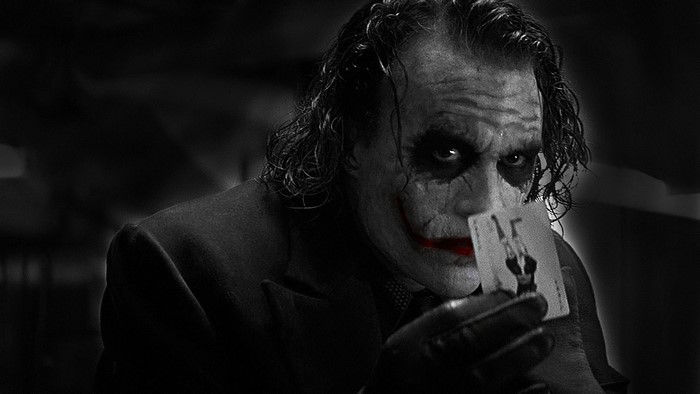 The Joker holding a playing card
