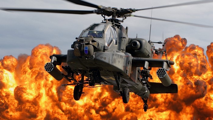 Apache helicopter flying through explosions