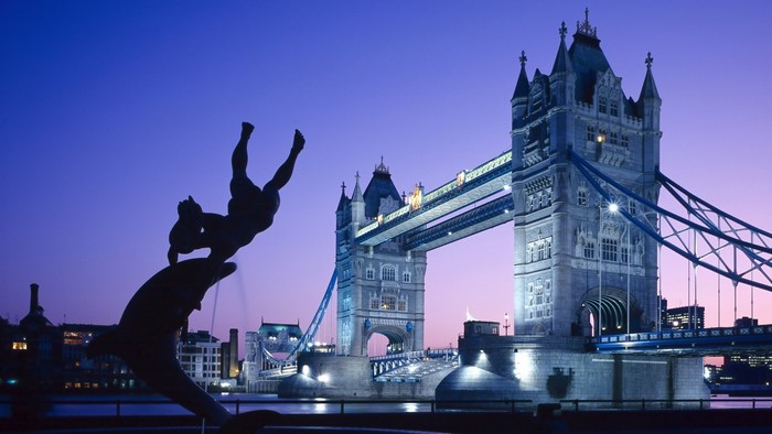 Tower Bridge and statue at dusk