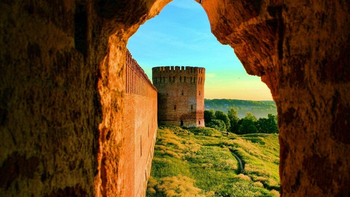 Ancient brick fort wall and tower at sunrise