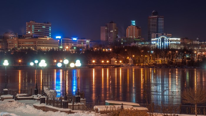 Winter Cityscape at Night with Frozen River