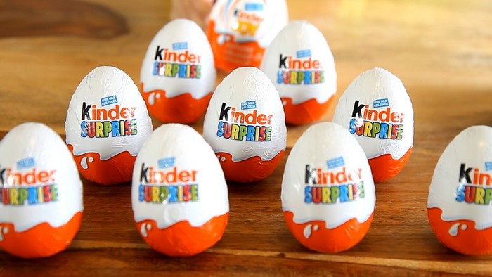 Kinder Surprise eggs on a wooden surface