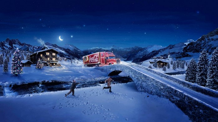 Coca-Cola truck in a snowy mountain village at night