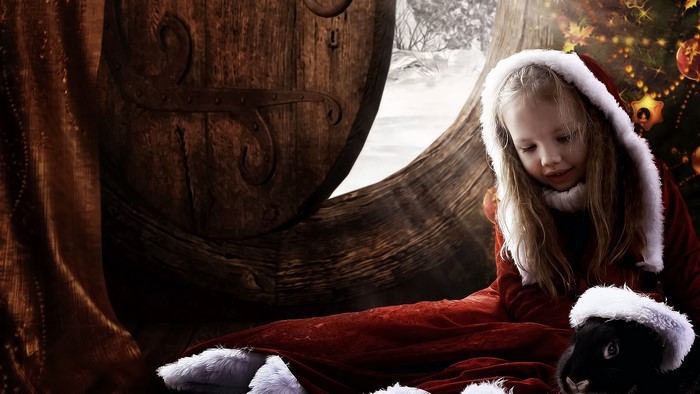 Girl in Santa costume with rabbit and Christmas tree