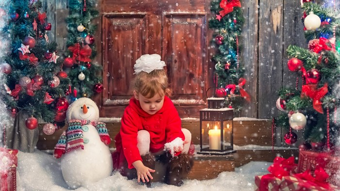 Girl and Snowman by Christmas Trees